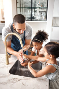 Father and children enjoying fresh clean water